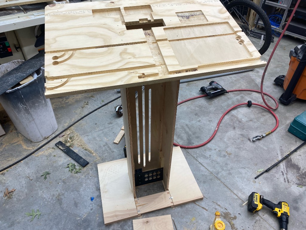 Plywood pulpit pedestal with CNC cutouts in a workshop
