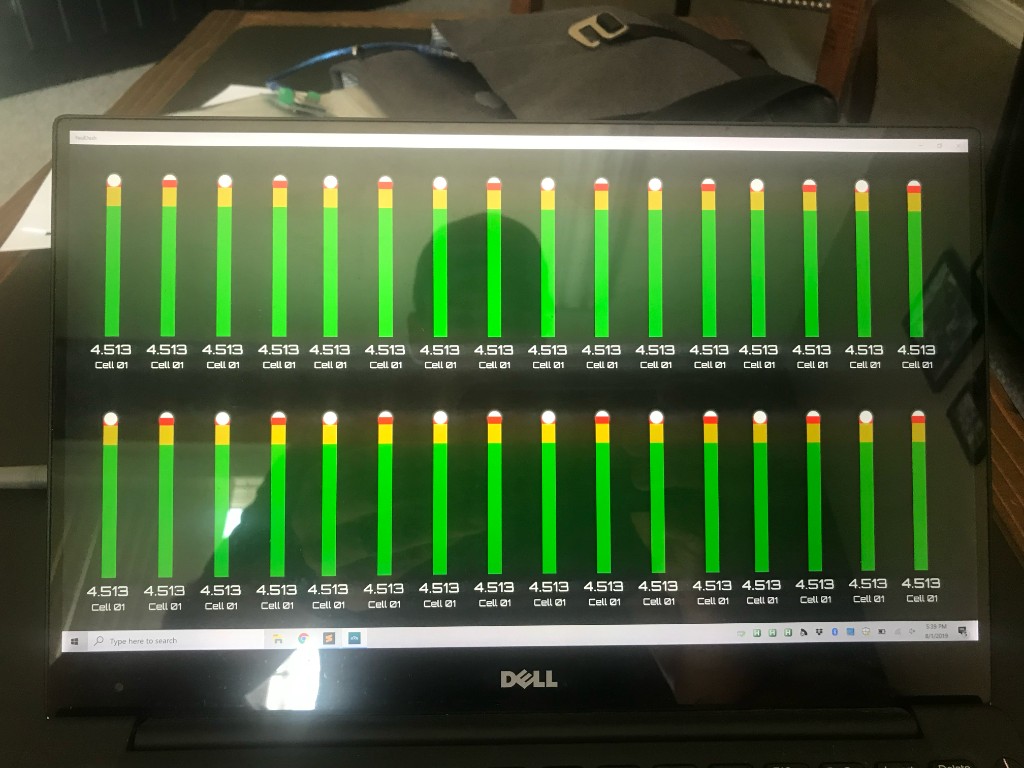 Laptop screen showing TeslaDash battery cell voltage bars